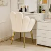 A cream-colored velvet chair with gold legs in front of a white vanity table. Podgląd zdjęcia produktu