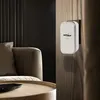 A wireless doorbell receiver is mounted on a wall next to a sofa and coffee table in a modern living room. Náhľad obrázku produktu