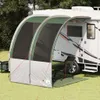 A tarp awning attached to a recreational vehicle (RV) on a grassy area. Anteprima dell’immagine prodotto