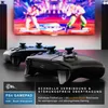 Two black game controllers are placed on a dark surface in front of a large television screen displaying a video game. Produktbild-Vorschau