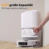 A hand is shown inserting a dust bag into a white robotic vacuum cleaner docking station. Produktbild-Vorschau