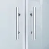 A close-up view of two chrome handles on a glass shower door. Produktbild-Vorschau