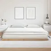 A minimalist bedroom scene featuring a low-profile wooden bed frame with a mattress and bedding. Voir les images du produit