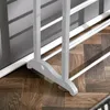 Close-up view of the base of a white garment rack with multiple bars, standing on a wooden floor. Produktbild-Vorschau
