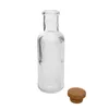 A clear glass bottle with vertical ridges and a cork stopper are shown against a white background. Náhľad obrázku produktu