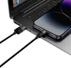 A close-up shot of a smartphone and a laptop connected by charging cables. Produktbild-Vorschau
