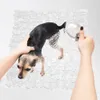 A small dog is being bathed on a textured mat. Náhľad obrázku produktu