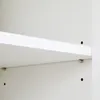 A close-up view of a white shelf with visible holes for mounting and shelf support pins. Náhled obrázku produktu