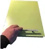 A hand holding a silver slider on a green surface. Produktbild-Vorschau