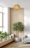 A living room with a pendant light, a sofa, plants, and a wooden wall panel. Podgląd zdjęcia produktu