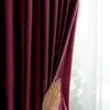 A hand is pulling back a burgundy curtain to reveal a sheer white curtain behind it. Produktbild-Vorschau
