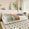 A bedroom scene featuring a white daybed with bedding and decorative pillows. Podgląd zdjęcia produktu