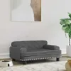 A dark gray pet sofa with tufted back and silver stud accents is placed on a rug in a room with a plant and a framed picture on the wall. Podgląd zdjęcia produktu