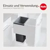 A built-in kitchen waste bin system with two compartments, one dark gray and one white, shown installed in a cabinet. Voir les images du produit