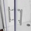 Close-up of two chrome shower door handles on a glass shower enclosure with marble-patterned walls in the background. Produktbild-Vorschau