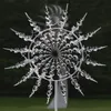 A kinetic wind spinner made of metal and glass beads, displayed outdoors in a garden setting. Anteprima dell’immagine prodotto