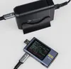 A black GaN charger and a blue USB tester are shown on a light gray background. Anteprima dell’immagine prodotto