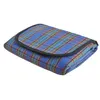 A folded picnic blanket with a blue, green, and red plaid pattern and a black border. Produktbild-Vorschau