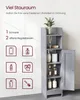 A tall, narrow gray bathroom cabinet with its door open, displaying shelves with various bathroom items. Icons representing items that can be stored are shown to the left. Podgląd zdjęcia produktu