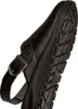 A close-up, side view of a black clog shoe, focusing on the sole and strap. Produktbild-Vorschau