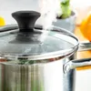A close-up shot of a steaming pot with a glass lid. Anteprima dell’immagine prodotto