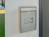 A modern mailbox mounted on a white wall. Podgląd zdjęcia produktu