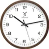 A close-up studio shot of a round wall clock with a brown wooden frame and a white face. Voir les images du produit