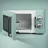 A retro-style microwave oven with its door open, showing the interior and a wire rack. Produktbild-Vorschau
