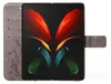 A folded smartphone in a protective case with a floral pattern. Produktbild-Vorschau