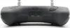 The back view of a black remote control with two antennas, a USB-C port, and an audio jack. Produktbild-Vorschau
