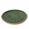 A green ceramic plate with a carved pattern and a wooden rim, shown from a diagonal angle against a white background. Produktbild-Vorschau