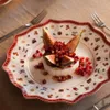 A close-up of a festive dessert on a decorative plate. Produktbild-Vorschau