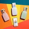 Three Instax mini Link 3 printers in pink, white, and green, each printing a photo, with a smartphone displaying a photo in the foreground, arranged on a colorful background. Náhľad obrázku produktu