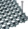 A close-up view of a green plastic grid system, with a silver screw inserted into one of the hexagonal openings. Voir les images du produit
