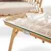 A close-up shot of a wicker and glass coffee table, part of a patio furniture set. Náhľad obrázku produktu
