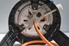 Close-up view of the underside of a gas appliance, showing a metal wrench attached to a gas hose. Produktbild-Vorschau