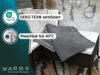 A gray blanket is folded on top of outdoor furniture cushions, with marketing text and logos on the left side. Produktbild-Vorschau