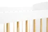 A close-up view of the top railing and wooden slats of a white crib. Produktbild-Vorschau