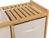 A close-up view of a bamboo shelf unit with fabric storage baskets. Podgląd zdjęcia produktu