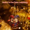A decorative owl figurine dressed as a jester, hanging from a Christmas tree. Produktbild-Vorschau