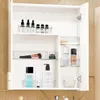 An open medicine cabinet filled with various cosmetic and skincare products organized in clear plastic bins. Náhled obrázku produktu