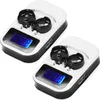 Two white and black LCD universal battery chargers are shown against a white background. Náhled obrázku produktu
