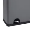 A close-up view of the bottom corner of a gray trash can, showing a black pedal. Voir les images du produit