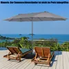 A patio with two lounge chairs and a large umbrella overlooking the ocean. Podgląd zdjęcia produktu