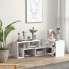 A white modular TV stand with decorative items and books, set up in a living room. Produktbild-Vorschau