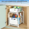 A two-tier white metal organizer shelf unit with drawers, filled with cleaning supplies and boxes, placed inside a cabinet under a sink. Voir les images du produit