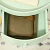 A close-up view of an open drawer of a light green side table, revealing a brown leather-bound notebook inside. Voir les images du produit