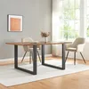 A dining table with two chairs in a well-lit room with a large window. Produktbild-Vorschau