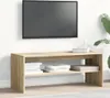 A TV stand with books on it, in front of a white wall with a TV mounted above it. Náhled obrázku produktu