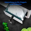 A close-up shot of an ice maker's ice bin filled with nugget ice, with a scoop inside. Mint leaves and lime slices are visible in the foreground. Produktbild-Vorschau